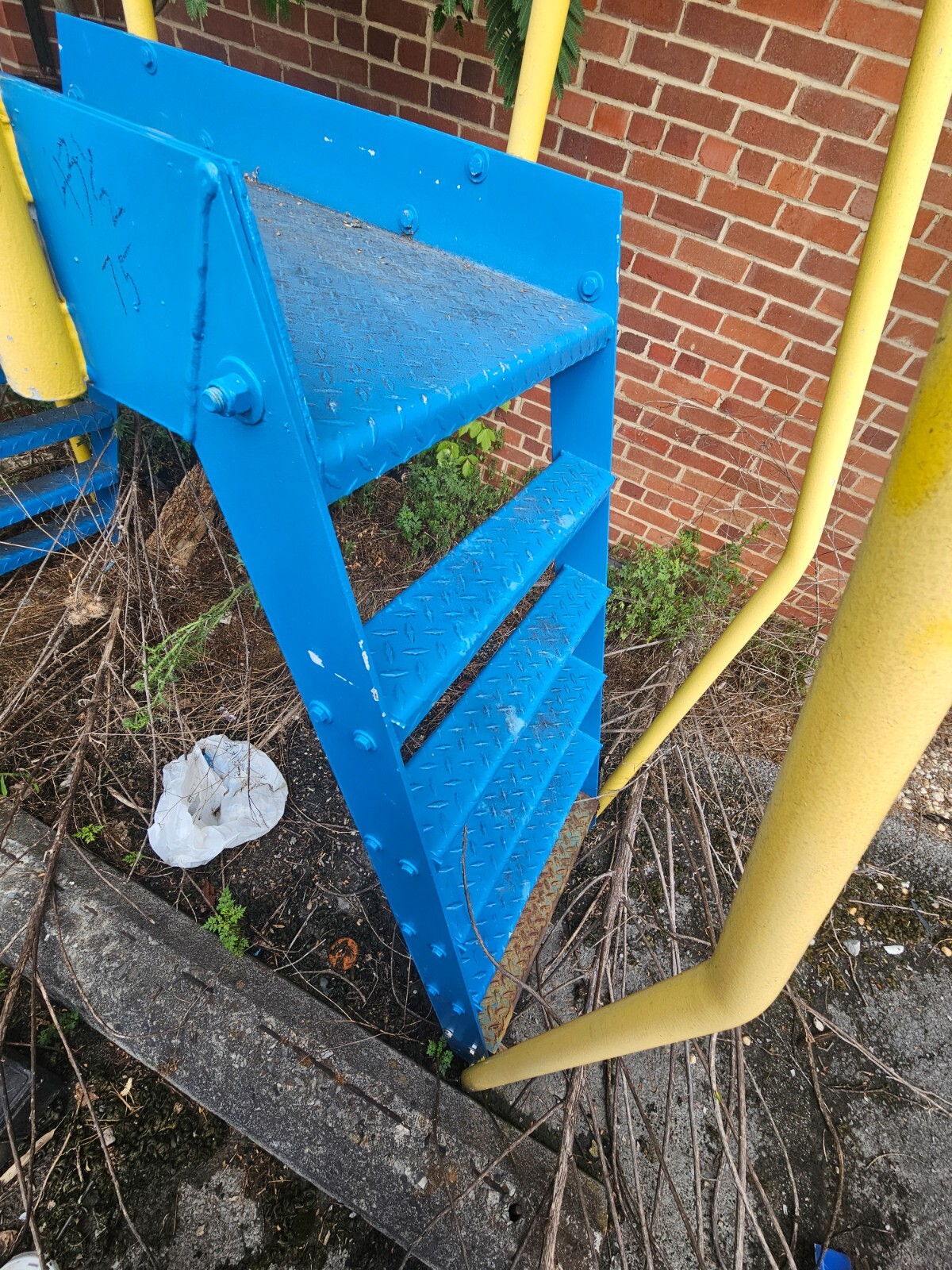 blue and yellow crossover stairs with safety rails